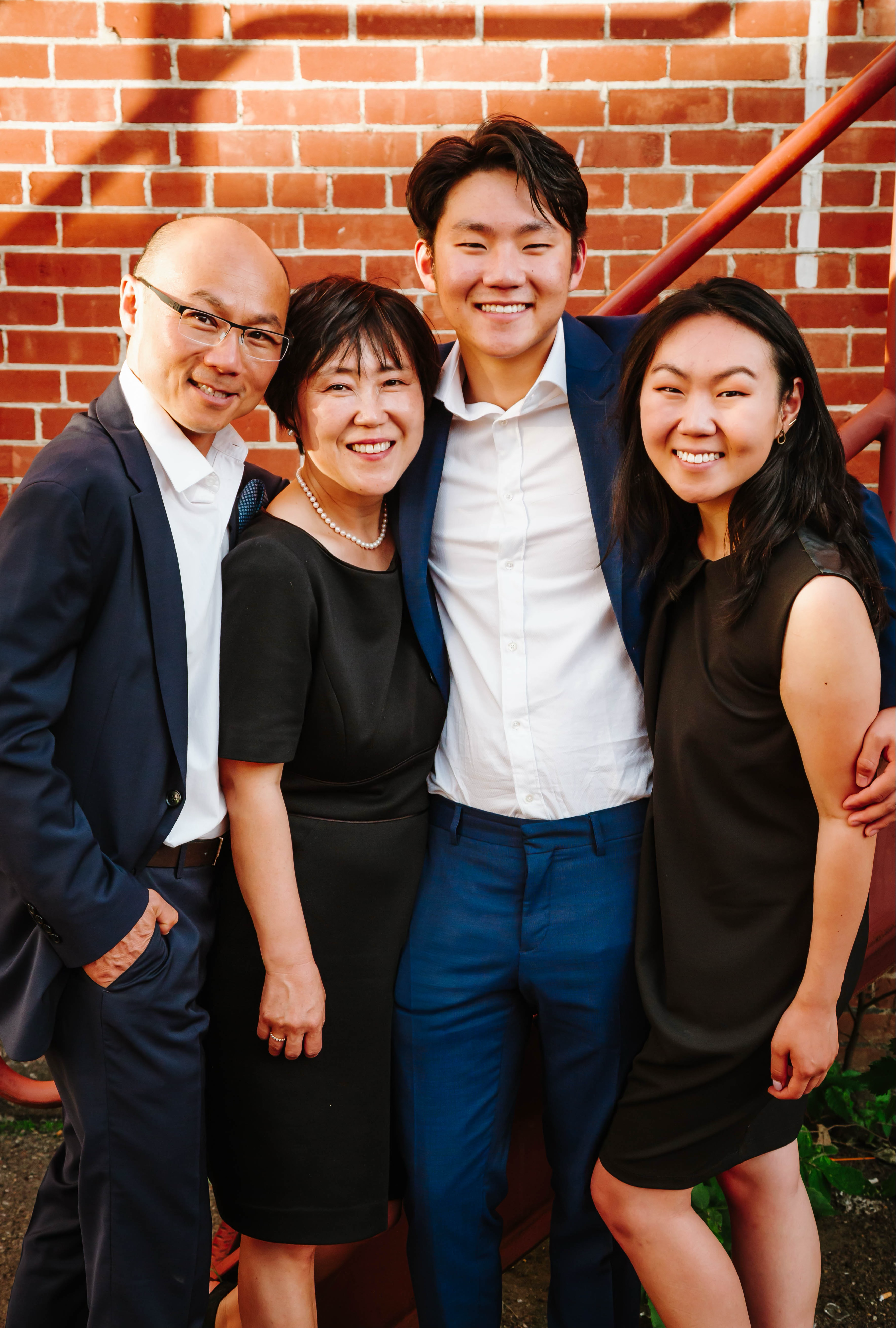 Ko family by brick wall